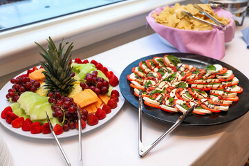 fruits, tomatoes, cheese, and charcuterie on a platter, symbolizing a delectable and balanced culinary experience