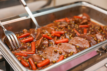 Potluck party with a delightful spread of meat, vegetables, and bread dishes, embodying community and culinary diversity