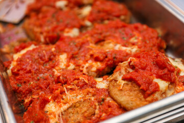 Potluck party with a delightful spread of meat, vegetables, and bread dishes, embodying community and culinary diversity