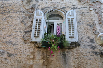 Fototapeta na wymiar Window of Mediterranean houses in town Porec, Croatia