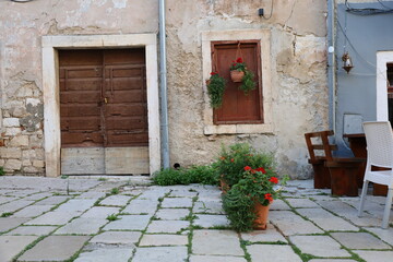 Fototapeta na wymiar Window of Mediterranean houses in town Porec, Croatia. Streets of Porec with colorful building facades in Croatia, Istria. 