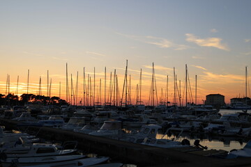 Sunset with boat silhouettes on the Adriatic sea in Porec, Istria, Croatia, Europe. Beautiful...