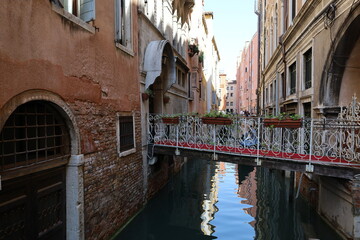 Fototapeta na wymiar Canal in Venice, Italy, Europe. Architecture and landmark of Venice. Narrow canal with boat and bridge in Venice, Italy. 