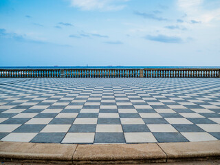 Stunning view of Terrazza Mascagni, picturesque belvedere terrace with a paved checkerboard surface, Livorno, Tuscany, Italy
 - obrazy, fototapety, plakaty