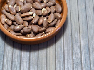 Fototapeta premium detail of a roasted almond bowl on a wooden table