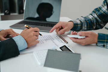 A real estate agent is talking with a client about buying a home or getting home insurance. Real estate agent buys, sells a house, agrees to buy a house.