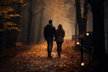 Foto auf Leinwand a couple walking on a forest road in an autumn morning © urdialex