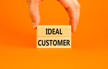 Ideal customer symbol. Concept words Ideal customer on beautiful wooden blocks. Beautiful orange table orange background. Businessman hand. Business ideal customer concept. Copy space.