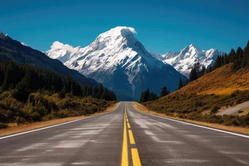 Papier Peint photo Aoraki/Mount Cook Road leading to a snowcapped mountain in a beautiful landscape scenery