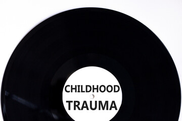 Childhood trauma symbol. Concept words Childhood trauma on beautiful black vinyl disk. Beautiful...