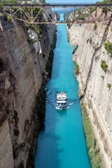 Tourist ship crosses the Corinth canal, the canal that separates Peloponnese from continental...