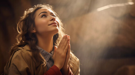 young girl praying in a church  - obrazy, fototapety, plakaty
