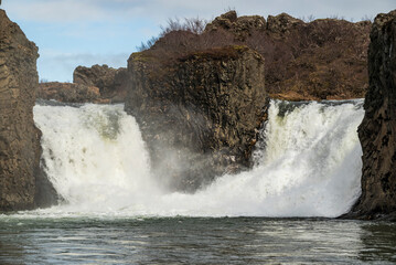 Close-up of the mighty Hjálparfoss waterfall in Þjórsárdalur valley, Iceland. The divided...
