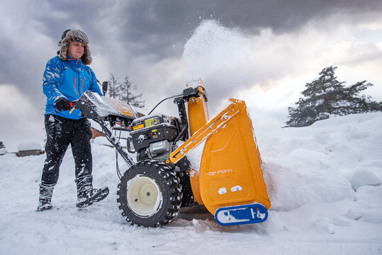 Snow Removal Equipment. Clearing snow from access road using a snow blower.