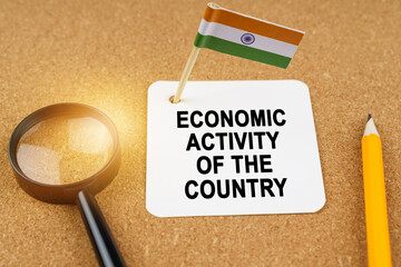On the table is the flag of India and a sheet of paper with the inscription - economic activity of...
