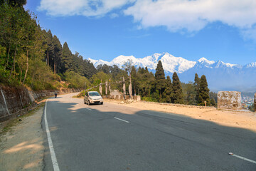 Scenic mountain road near Lava Kalimpong, India, with the Kachenjunga Himalaya range in the background