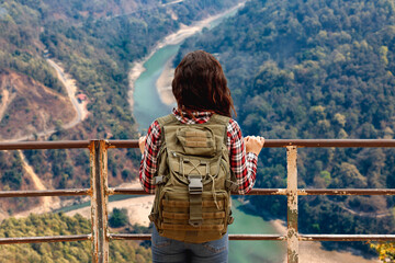 Girl tourist enjoy an aerial view of the Teesta river valley from Lover's point at Darjeeling, India
