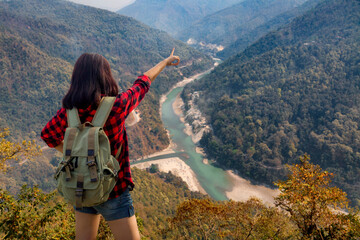 Young girl tourist enjoys a scenic aerial view of Teesta river and Himalayan landscape from Lover's...