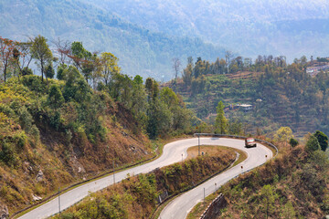 Winding mountain road with scenic landscape on way to Kolakham from Darjeeling, a popular hill station of India