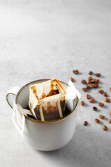 Fototapeta na wymiar Drip Coffee Bag in a Mug, Quick Way to Brew Ground Coffee Using Paper Type Filter