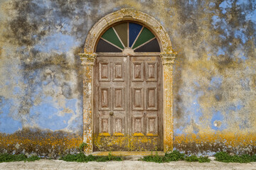 Old wooden door and moldy painted wall texture background.