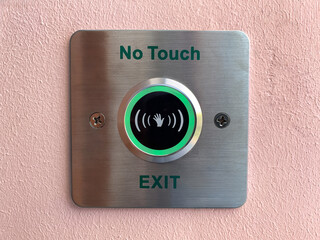 Contactless stainless steel door unlocking button on the wall