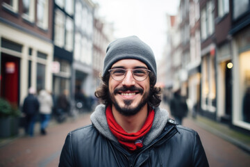 Portrait of a young smiling man standing on the city street in Amsterdam