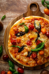 Pizza Margherita on a wooden background