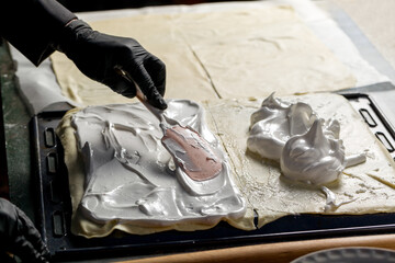 The process of creating meringue. The confectioner prepares the meringue