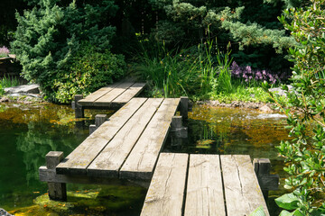 zigzag bridge over a pond in a Japanese garden