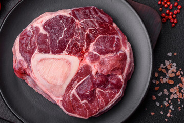 Fresh beef ossobuco steak with salt, spices and herbs