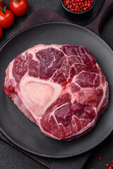 Fresh beef ossobuco steak with salt, spices and herbs
