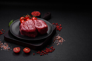 Raw fillet steak mignon beef with salt, spices and herbs