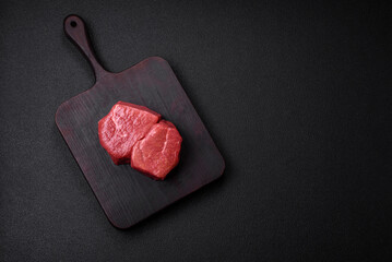 Raw fillet steak mignon beef with salt, spices and herbs