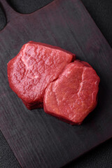 Raw fillet steak mignon beef with salt, spices and herbs
