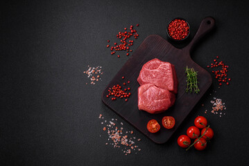 Raw fillet steak mignon beef with salt, spices and herbs