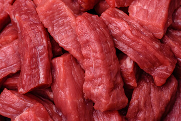 Raw organic meat beef or lamb cut into slices with salt, spices and herbs