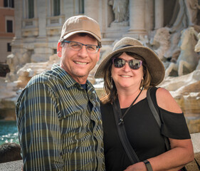 Smiling caucasian tourist couple on holiday in Rome in front of Trevi fountain - 646126134