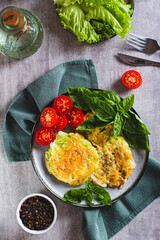 Baked cabbage steaks, fresh tomatoes and basil on a plate top and vertical view