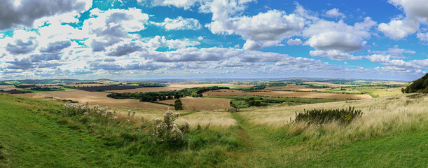Panorma of post harvest English summer fields on a sunny summer day in Befordshire, UK.