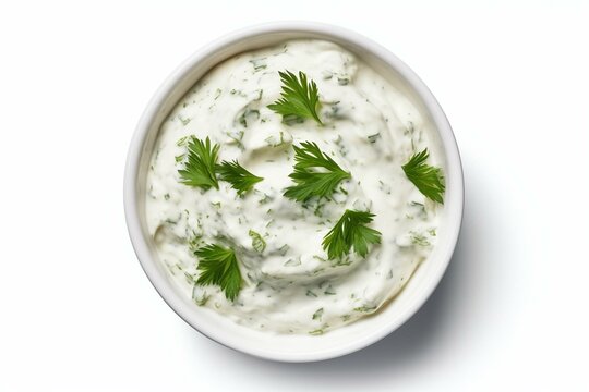 Sour cream dip with herbs in a bowl, isolated on white background, seen from above. Generative AI