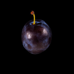 Purple plum isolated on solid black background with Clipping path