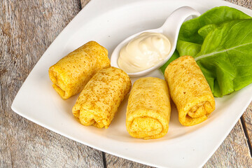 Stuffed pancakes with cream sauce