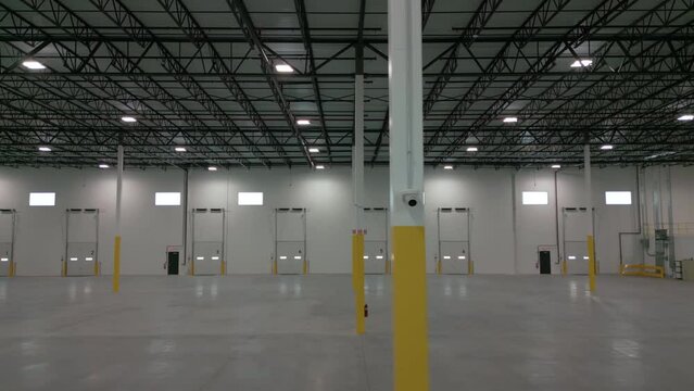 Inside large commercial warehouse. Move camera. Wide shot