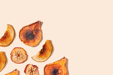 Dried apple and pear slices on a beige background. Healthy food, vitamins concept. Green living and eco-friendly products. Autumn season minimal wallpaper concept. Copy space. Space for text