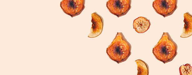 Dried apple and pear slices on a beige background. Healthy food, vitamins concept. Green living,...