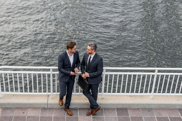 Colleague discuss. Business man talking on outdoor meeting. Devising big plans with the boss. Business partners are discussing, teamwork and chatting outdoor. Business man sharing business idea.