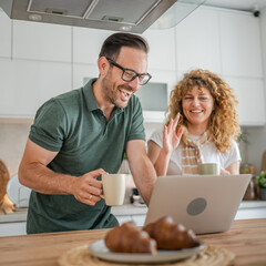 happy couple man and woman husband and wife morning routine use laptop