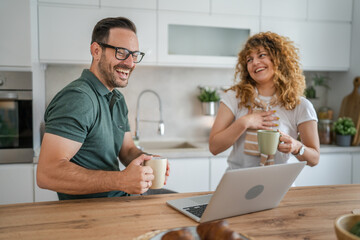 Fototapeta premium happy couple man and woman husband and wife morning routine use laptop