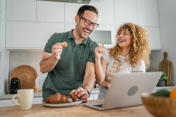 happy couple man and woman husband and wife morning routine use laptop